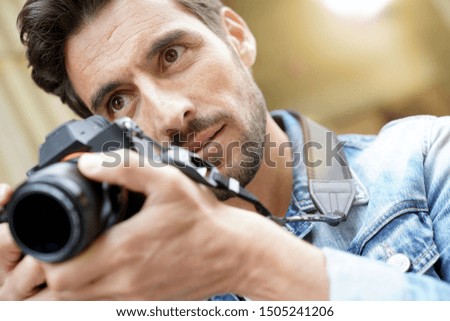 Photographer taking pictures in European city