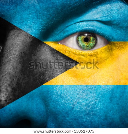 Bahamian flag painted on a man's face to support his country Bahamas