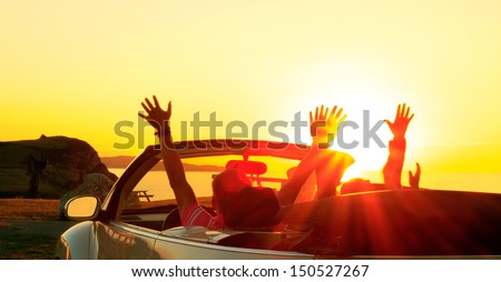 Happy family  in a cabriolet convertible car at the sunset in summer Royalty-Free Stock Photo #150527267