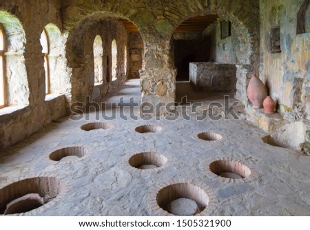 Georgia, Kvevri - vessels for making wine walled up in the ground in the premises of an ancient monastery Royalty-Free Stock Photo #1505321900