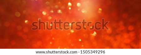 background of gold and orange glitter lights. de focused