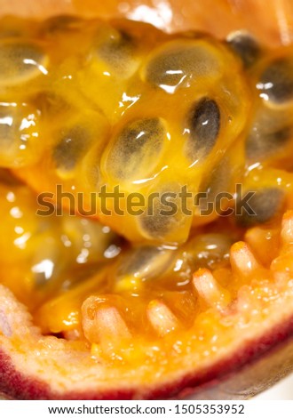 Juicy passion fruit pulp as a background. Macro