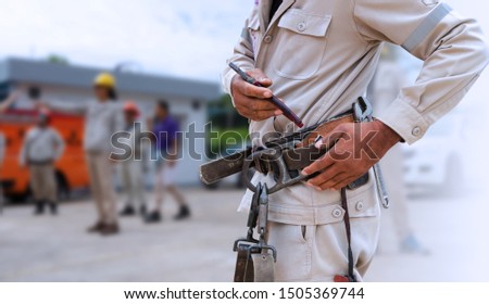 close up electrician with safety belt for personal protective equipment