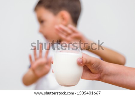 Kid refusing to drink milk. Lactose intolerance. Dairy Intolerant child refuses to drink milk Royalty-Free Stock Photo #1505401667