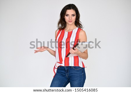 Concept photo portrait of a pretty beautiful brunette girl with excellent makeup in a striped t-shirt and blue jeans with a folder in hands on a white background. in different poses with emotions.