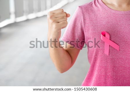 October Breast Cancer Awareness month, Woman in pink T- shirt with Pink Ribbon for supporting people living and illness. Healthcare, International women day and World cancer day concept Royalty-Free Stock Photo #1505430608
