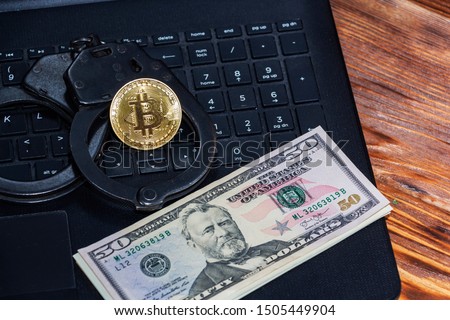 Police handcuffs and bitcoins. The concept of problems with the law in the illegal mining of cryptocurrencies and transactions with bitcoins