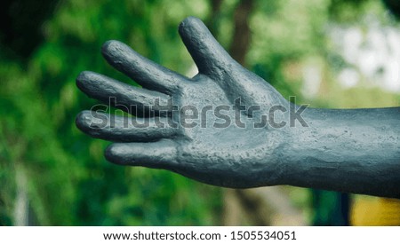 Artificial concrete black hands with fingers isolated unique photo