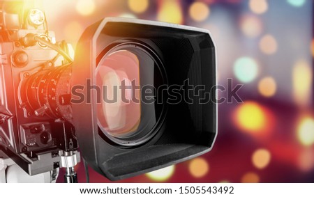 Close-up of a television camera lens on blurred background
