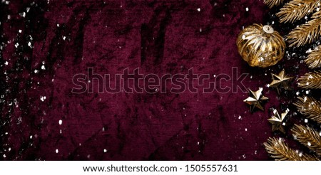 Merry Christmas and Happy Holidays greeting card, frame, banner. New Year. Christmas golden ornaments on purple background top view. Winter holiday theme. Flat lay.