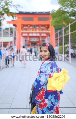Asian woman is wearing Yukata inside Fushimi Inari Shrine in Kyoto, Japan.