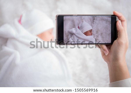 Mother take pictures of children