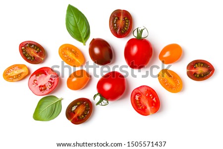 various colorful tomatoes and basil leaves isolated on white background. Top view, flat lay. Creative layout. Royalty-Free Stock Photo #1505571437