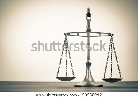 Law scales on table. Symbol of justice. Vintage sepia photo