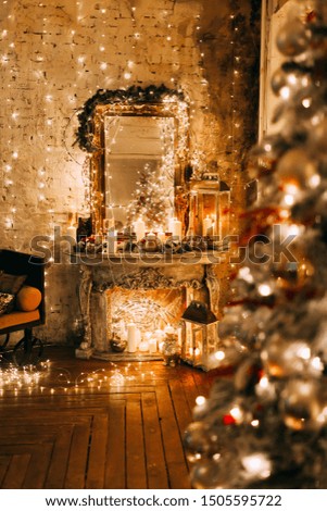 warm cozy magic evening in luxury old Christmas room fairy tale interior design,pahoramic windows,fire place  Xmas tree decorated by lights,gifts, candles, lanterns, garland lighting.New year holidays