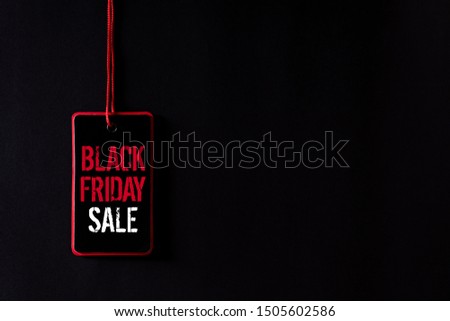 Black Friday Sale text on a red and black tag. Shopping concept.