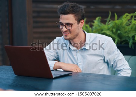 Cheerful business man desktop laptop education office