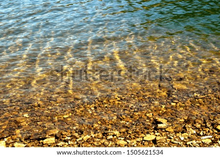 Water surface with small rocks all around them