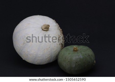 A green pumpkin and white pumpkin