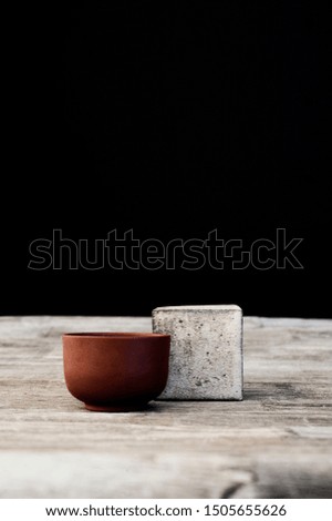 Zen Still Life Photography.Tea bowl and ceramic sqaure on old wood table. 