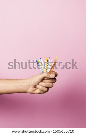 Person holding birthday candles with copy space