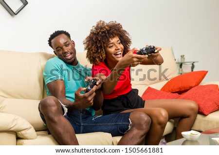 Black African American couple having fun playing video games