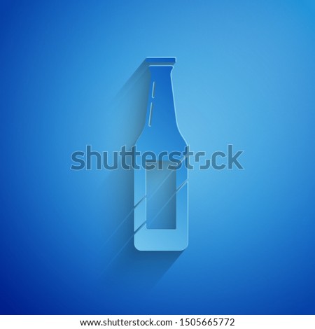 Paper cut Beer bottle icon isolated on blue background. Paper art style. Vector Illustration