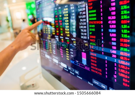 Stock exchange market business concept with selective focus effect. Display of Stock market quotes with finger pointing.