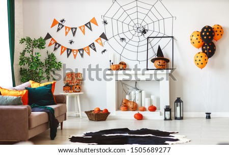 interior of the house decorated for Halloween pumpkins, webs and spiders
