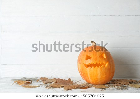 Halloween decorative pumpkin on wooden background, copy space
