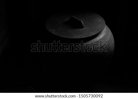 Black and white phoptgraph jar pottery in the old house at korat province of Thailand.