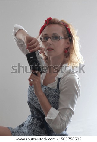 Woman portrait with retro camera dressed in apron. Food photographer concept.