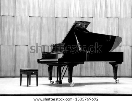 Grand piano set on stage, B&W Royalty-Free Stock Photo #1505769692
