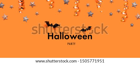 Halloween holiday concept with bats, ghost, stars over a orange background. Autumn holiday composition.