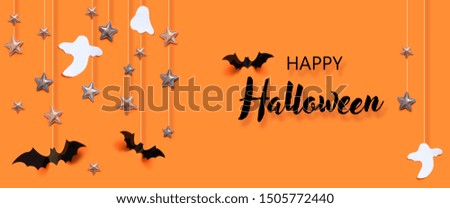 Halloween holiday concept with bats, ghost, spider web, stars over a orange background. Autumn holiday composition.