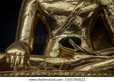 Golden statue of Buddha in lotus position