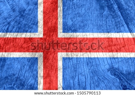 Iceland flag on an old wooden surface. Textured wallpaper background for design.