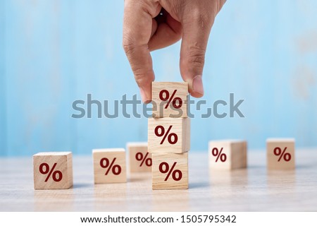 business man Hand putting wood cube block with percentage symbol icon. Interest rate,  financial, ranking and mortgage rates concept Royalty-Free Stock Photo #1505795342