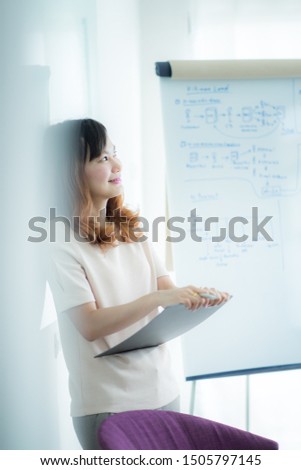 Portrait of young beautiful asian business woman in the office.