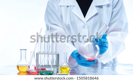 The teacher shows students an experiment with chemical liquids. Analysis in the laboratory. Chemical utensils and reagents. The study of chemistry.