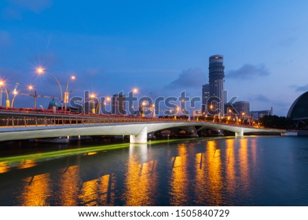 Esplanade Bridge at Singapore in twilight time on the beautiful city background.