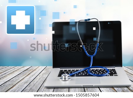 Laptop diagnosis with  stethoscope  on background