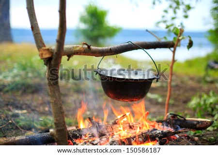cooking in a pot on the fire Royalty-Free Stock Photo #150586187