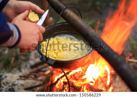 cooking in a pot on the fire Royalty-Free Stock Photo #150586229