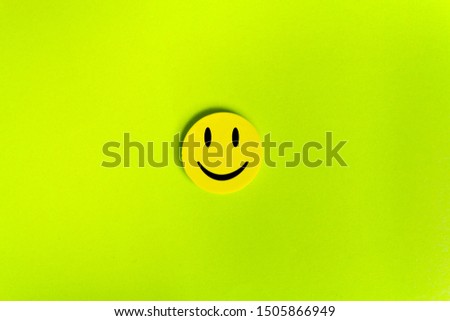 Positive Funny smiley face on a green cardboard background. Copy space for advertising and texts