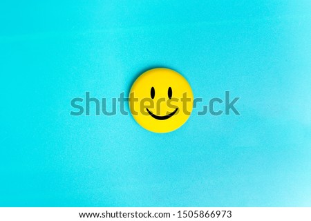 Positive Funny smiley face on a turquoise cardboard background. Copy space for advertising and texts Royalty-Free Stock Photo #1505866973