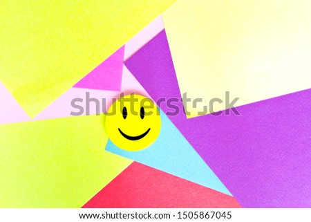 Positive Funny smiley face on a geometric cardboard background. Copy space for advertising and texts