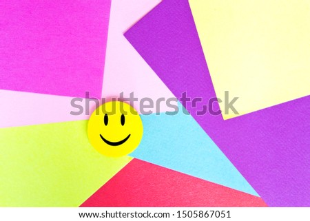 Positive Funny smiley face on a geometric cardboard background. Copy space for advertising and texts