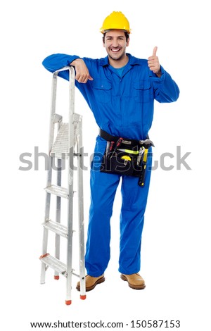 Young construction worker posing with step ladder