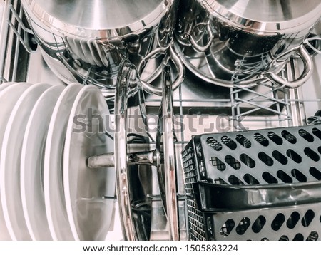 Open dishwasher machine with white clean dishes close up. Mobile photo